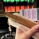 Bonnie's hand holding a Singing Straw in front of her DAW software